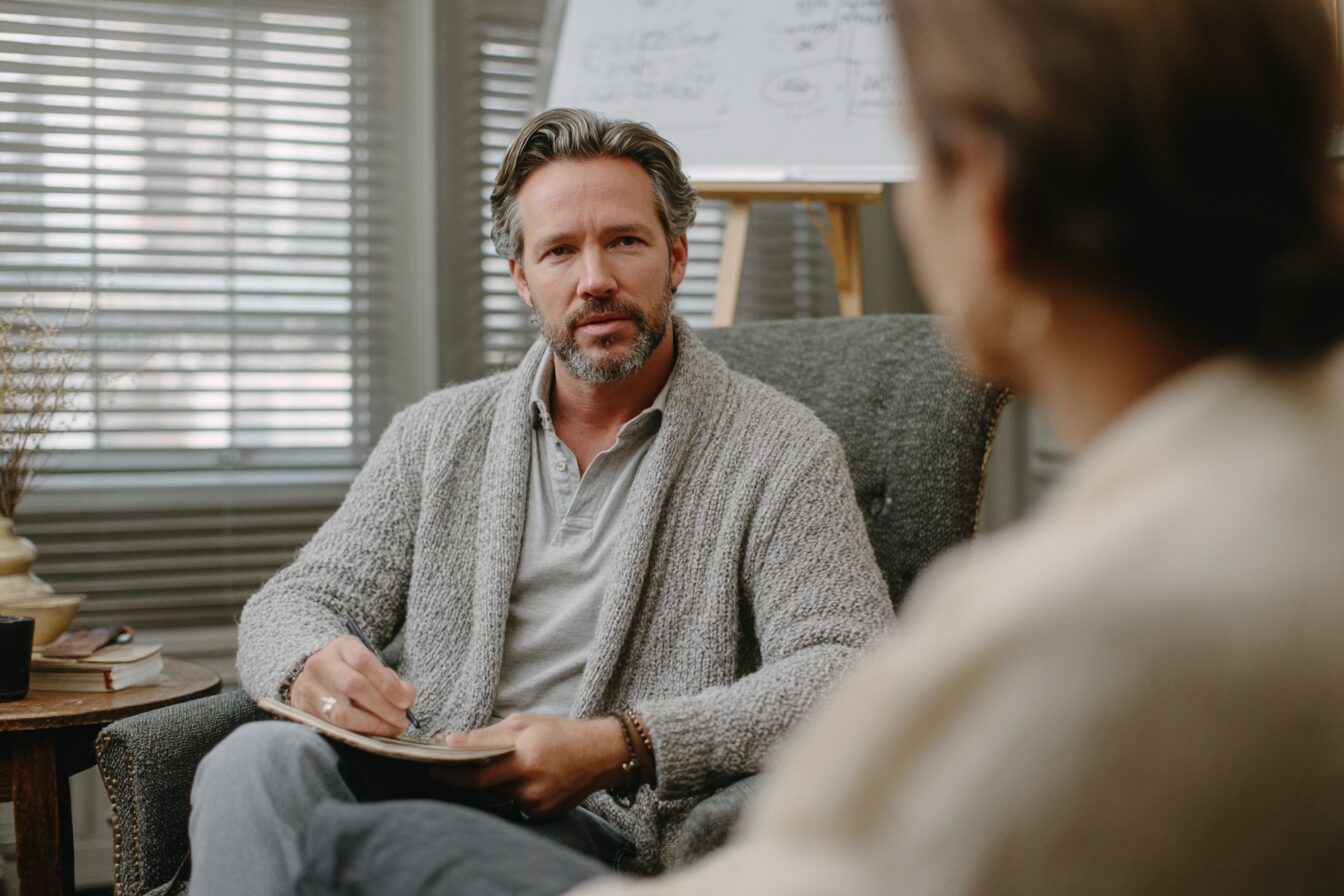 ADHD-informed couples therapist working with a couple after infidelity, using written notes and structured tools to support an ADHD-friendly recovery process.